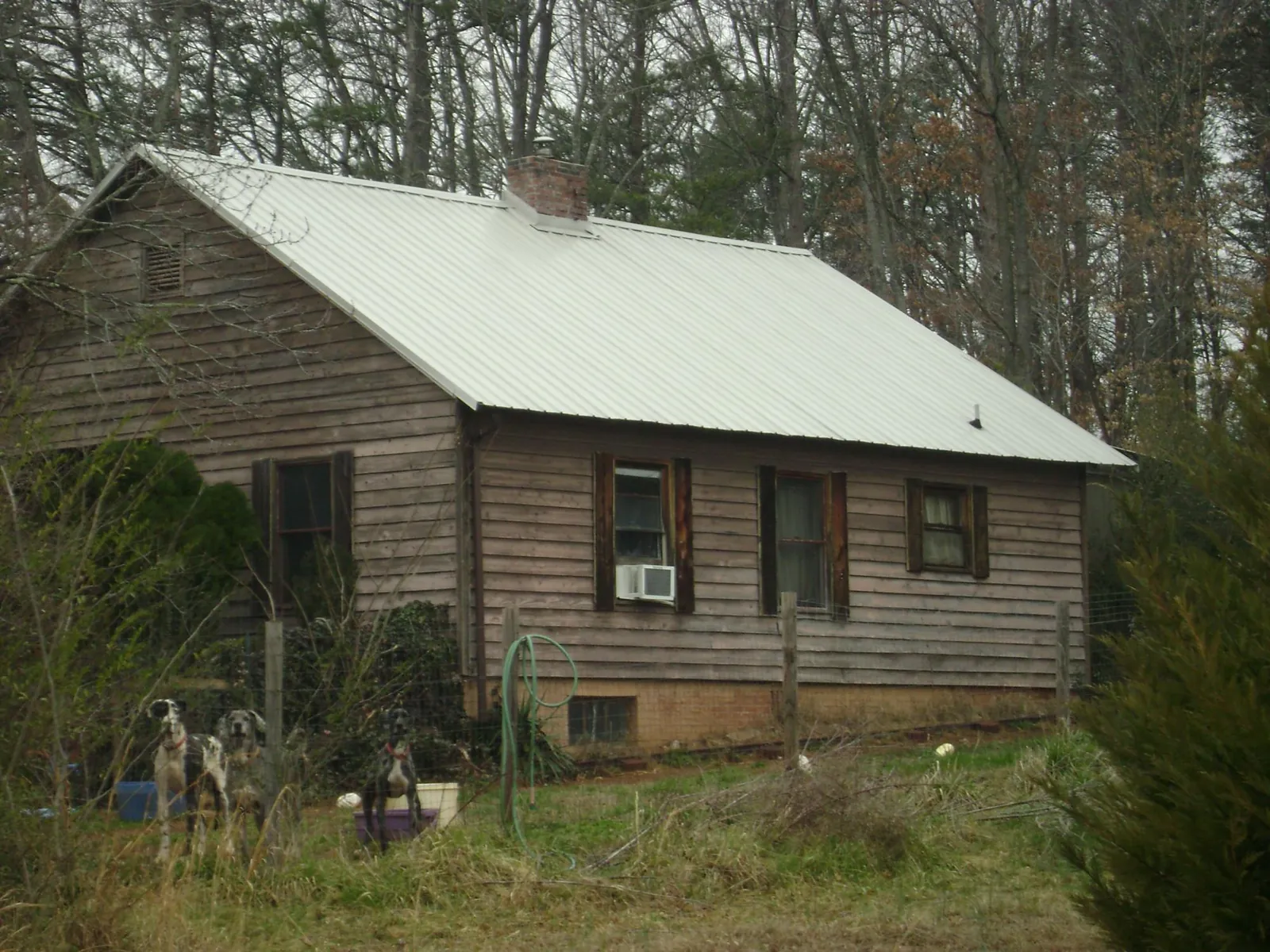 White metal roof on an old wood sided farmhouse, from a Metal Roof Installation job in Islandia